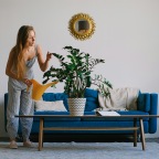 a woman watering a plant