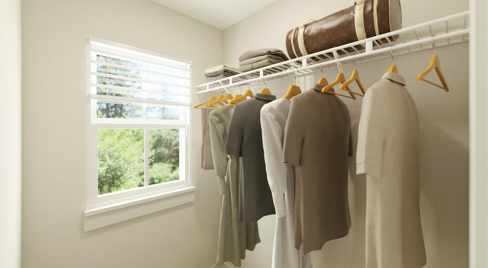 Ample closet space for your needs a group of clothes on a rack in a room