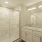 a bathroom with a tub sink and a shower unit
