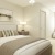a bedroom with a bed and lamps